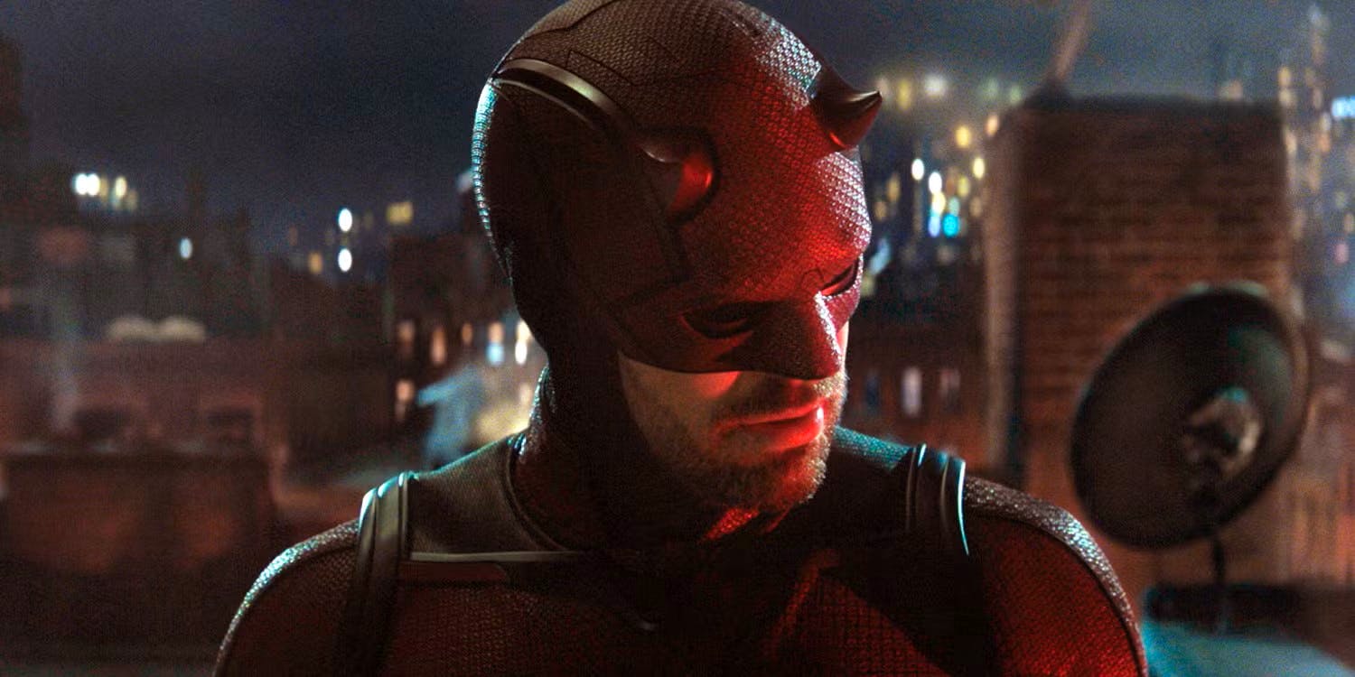 Daredevil stands on a rooftop in full costume, listening.