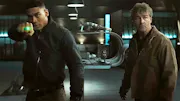 John Stewarts wielding the ring, standing beside Hal Jordan