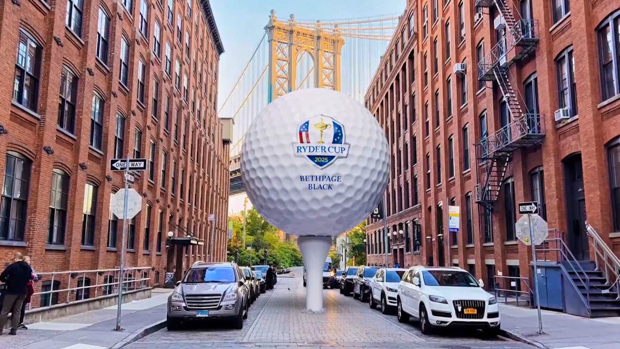 A giant golf ball teed up in the streets of New York, with the Ryder Cup logo on it.