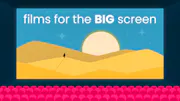 A giant cinema screen showing the movie Dune to an empty theatre.